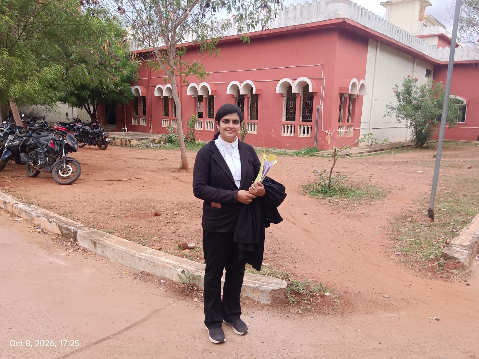 Advocate Priyanka in advocate attire outside a court building