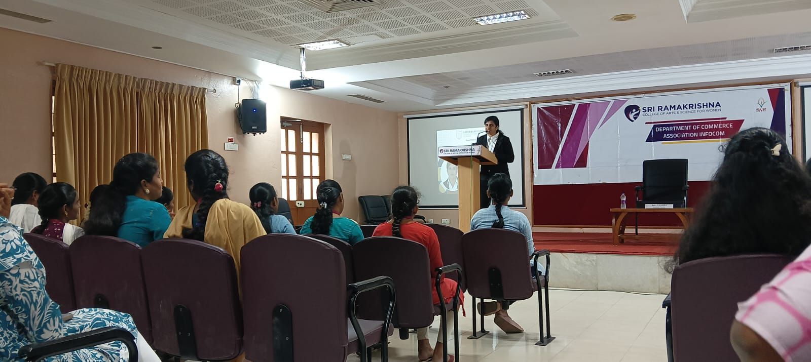 Seminar hall with an audience and a speaker at the podium